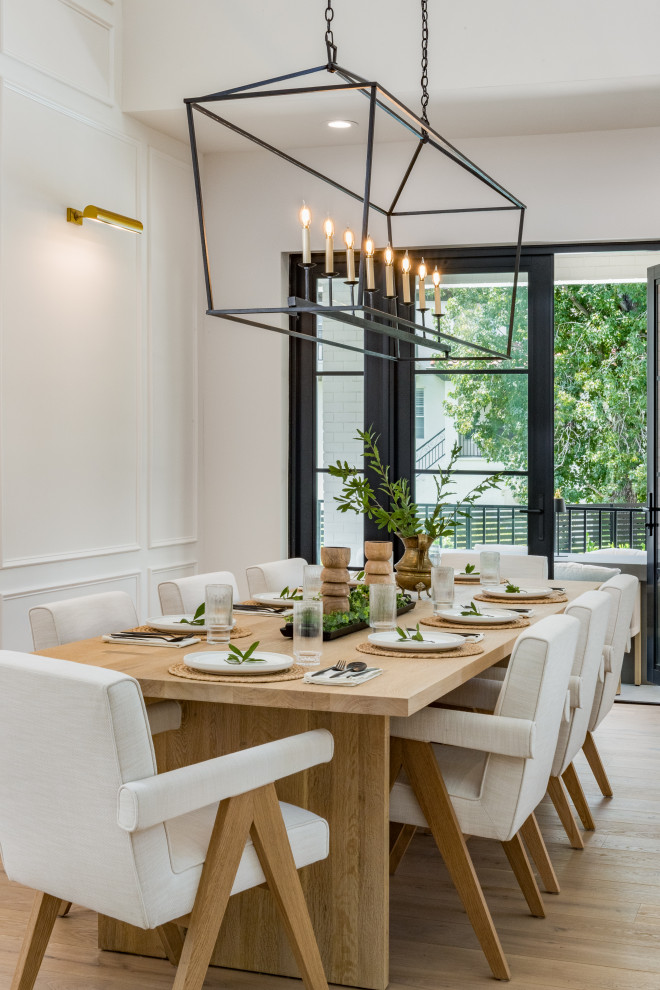 Dining room - transitional light wood floor, beige floor and wall paneling dining room idea in Tampa with white walls