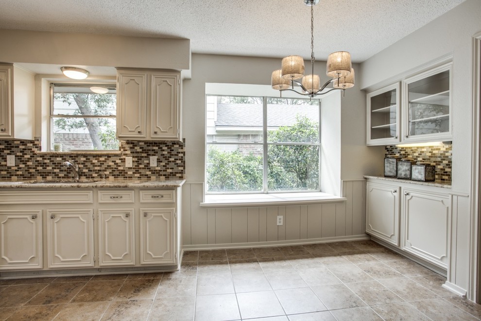 Example of a large transitional galley ceramic tile and beige floor open concept kitchen design in Dallas with an undermount sink, recessed-panel cabinets, white cabinets, granite countertops, multicolored backsplash, ceramic backsplash, stainless steel appliances, a peninsula and beige countertops
