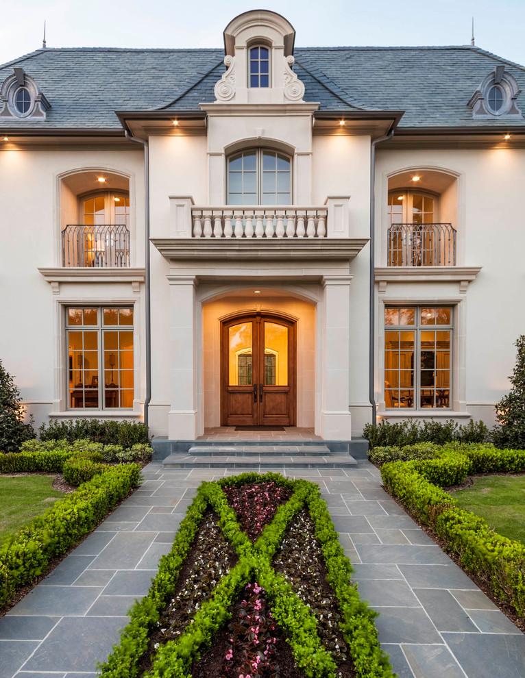 Inspiration for a traditional two-storey stucco beige exterior in Dallas.