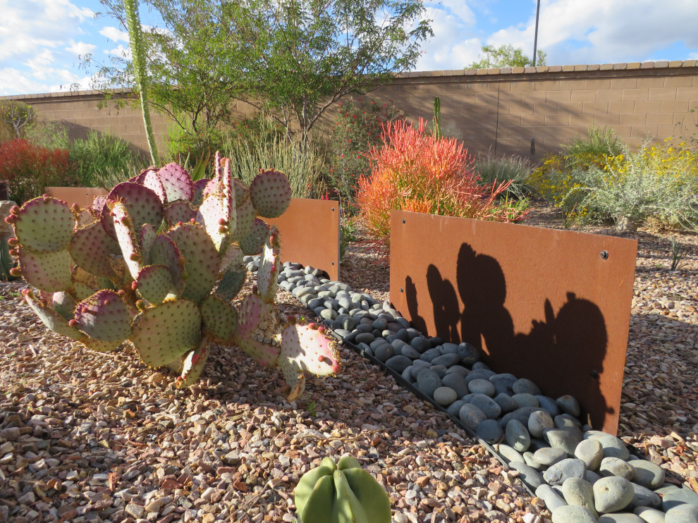 Photo of a medium sized modern back xeriscape full sun garden for summer in Milwaukee with concrete paving and a desert look.