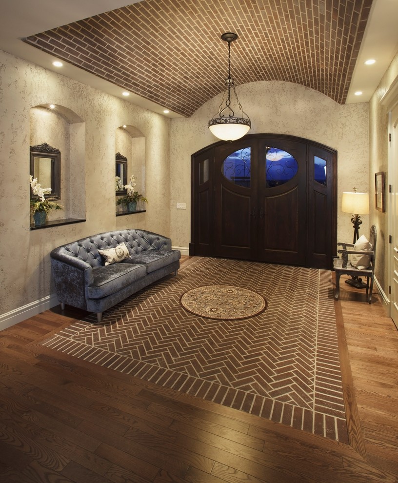 Inspiration for a traditional entryway in Calgary with brick floors.