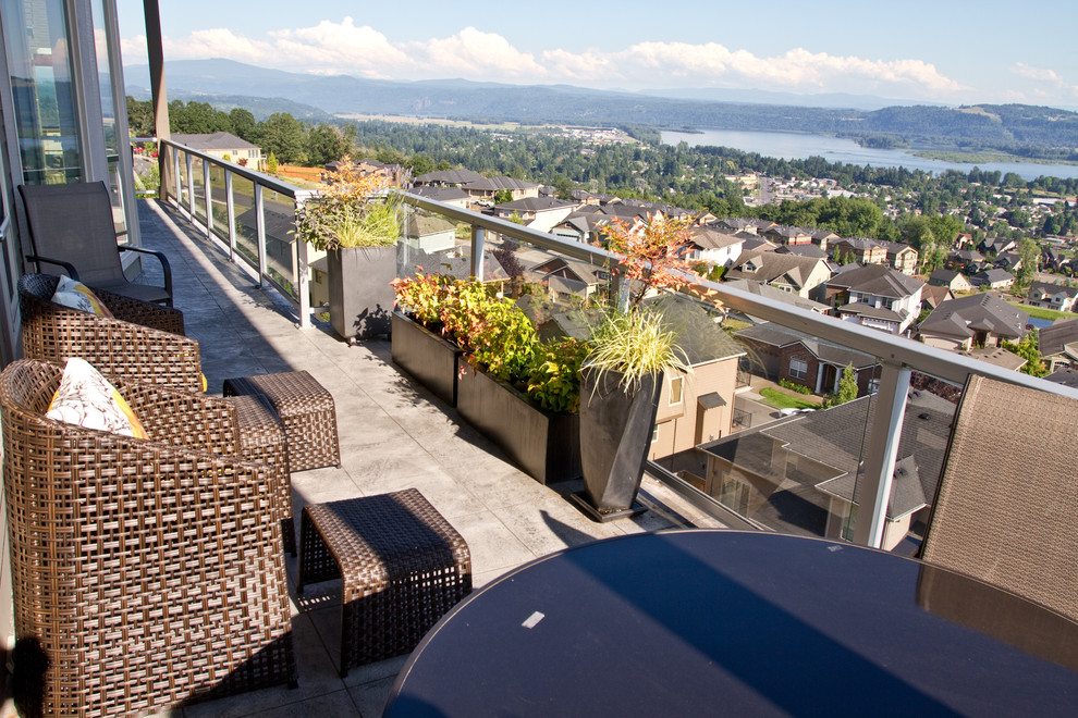 This is an example of an expansive contemporary rooftop deck in Portland with no cover.