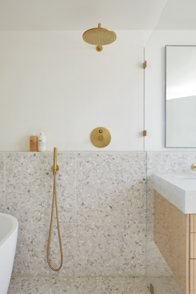 Photo of a small midcentury master bathroom in San Francisco with brown cabinets, a freestanding tub, a shower/bathtub combo, a wall-mount toilet, white tile, ceramic tile, white walls, terrazzo floors, an undermount sink, engineered quartz benchtops, white floor, an open shower, white benchtops, a double vanity and a floating vanity.