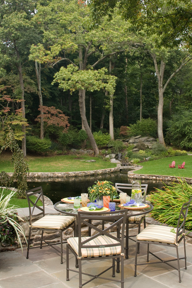 This is an example of a traditional garden in New York with a water feature.