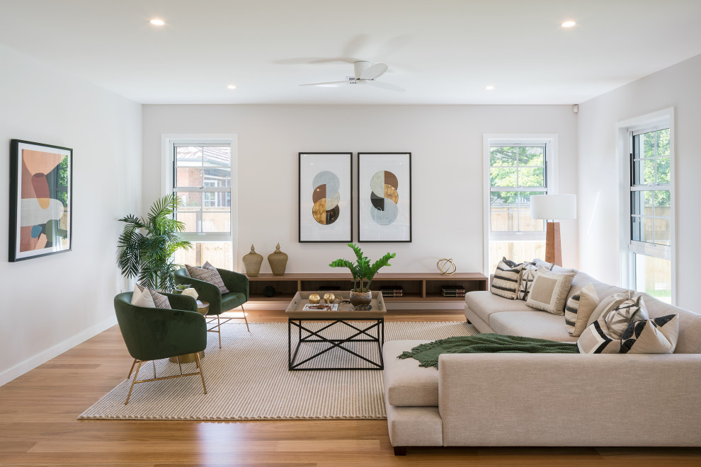Design ideas for a large contemporary open concept living room in Brisbane with white walls, medium hardwood floors and brown floor.
