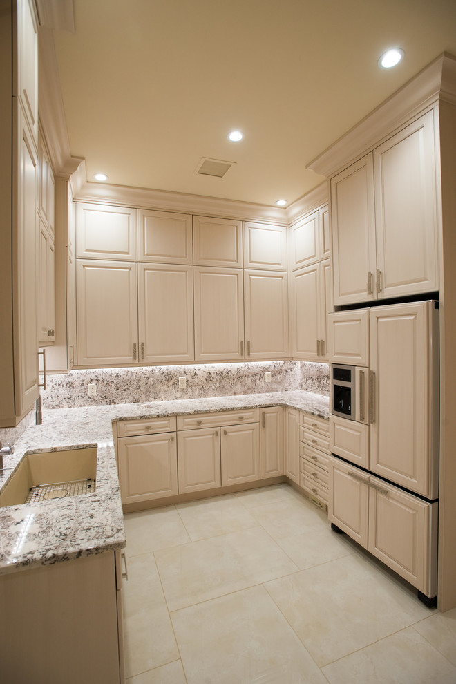 Inspiration for a timeless u-shaped kitchen pantry remodel with an undermount sink, raised-panel cabinets, white cabinets and granite countertops