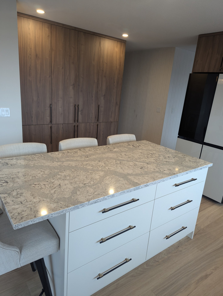 Modern kitchen island with white drawers and granite countertop