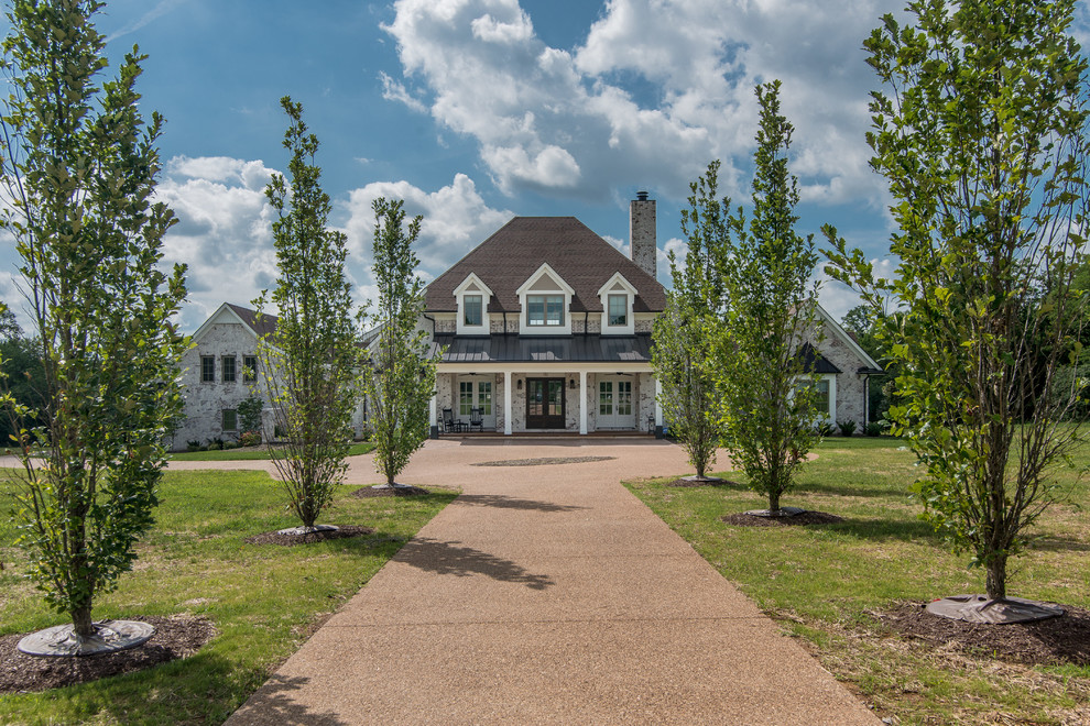 Transitional white two-story house exterior idea in Nashville with a mixed material roof