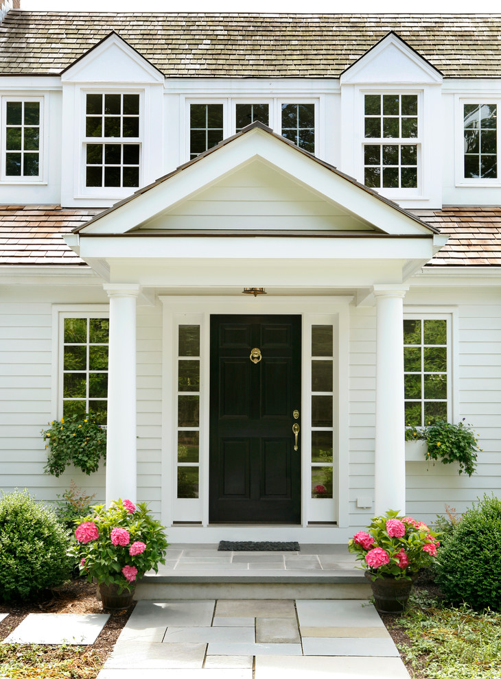 Expansive traditional front door in Other with white walls, a single front door, a black front door and grey floor.