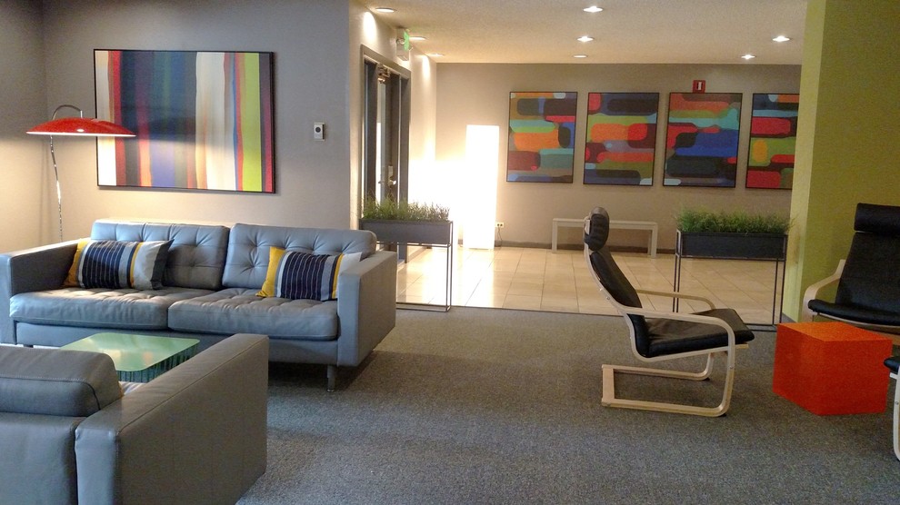 Inspiration for an expansive modern loft-style family room in Denver with grey walls and carpet.