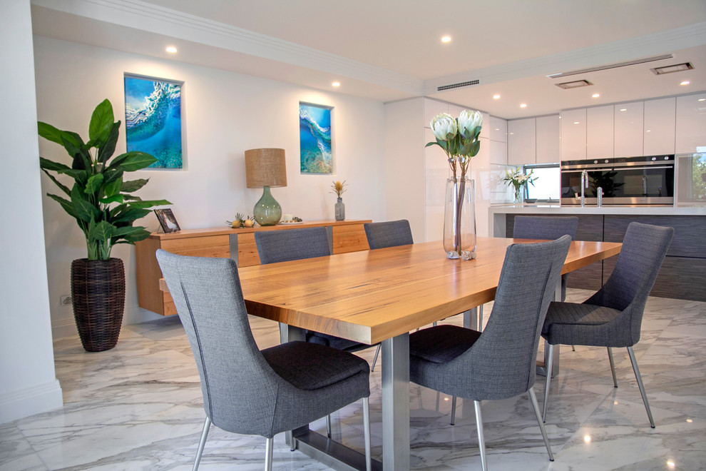 Photo of a contemporary kitchen/dining combo in Perth with marble floors, white walls and grey floor.