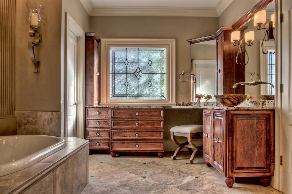 Design ideas for a large traditional master bathroom in Atlanta with a vessel sink, beaded inset cabinets, medium wood cabinets, granite benchtops, a drop-in tub, beige tile, porcelain tile, porcelain floors and grey walls.