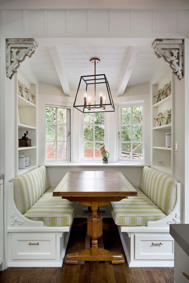 This is an example of a small traditional separate dining room in Other with white walls, dark hardwood floors, no fireplace and brown floor.