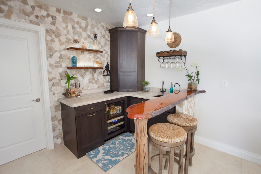 Photo of a small beach style u-shaped seated home bar in Miami with an undermount sink, shaker cabinets, dark wood cabinets and beige floor.
