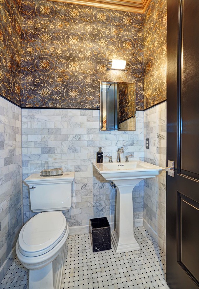 This is an example of a traditional powder room in Other with a pedestal sink, a two-piece toilet, white tile, multi-coloured walls and mosaic tile floors.