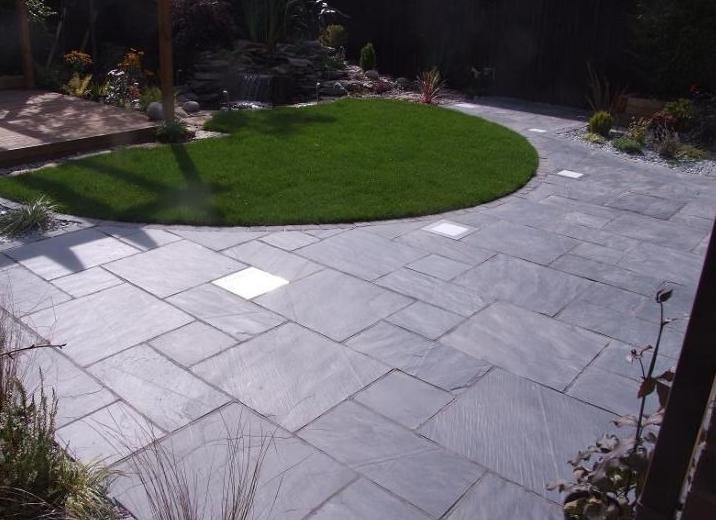 Mid-sized contemporary courtyard patio in Other with natural stone pavers.