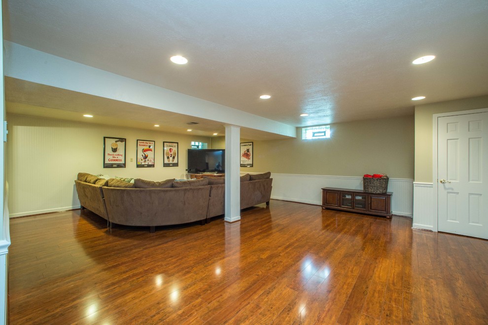 Photo of a large traditional look-out basement in Other with beige walls, dark hardwood floors and brown floor.