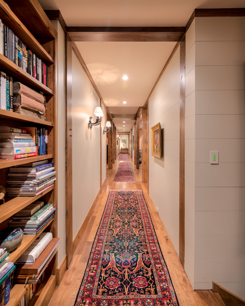 Hallway - rustic medium tone wood floor hallway idea in Denver with white walls