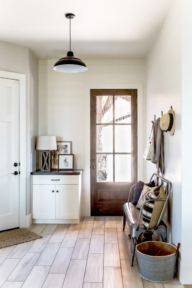 Large cottage porcelain tile entryway photo in Salt Lake City with white walls and a white front door