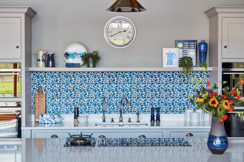 Inspiration for a large contemporary l-shaped open plan kitchen with an integrated sink, shaker cabinets, grey cabinets, quartz worktops, blue splashback, stone tiled splashback, stainless steel appliances, porcelain flooring, an island, grey floors and white worktops.