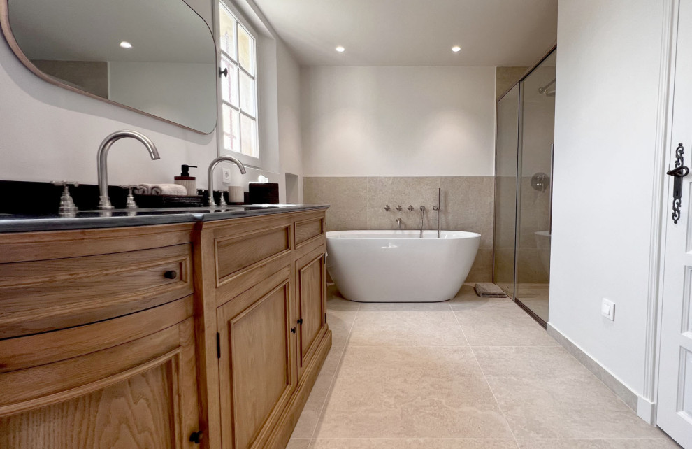 Design ideas for a mid-sized country master bathroom in Nice with beige cabinets, a curbless shower, a wall-mount toilet, white tile, limestone, beige walls, limestone floors, a console sink, white floor and a double vanity.