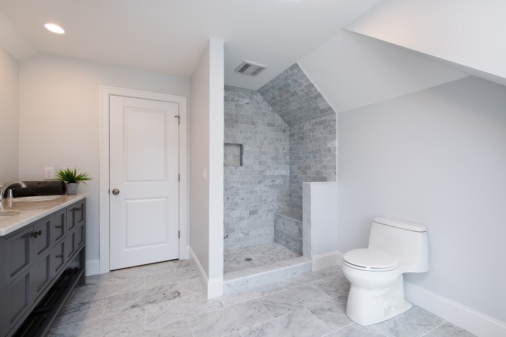 Example of a large transitional master gray tile, white tile and subway tile slate floor doorless shower design in Boston with shaker cabinets, gray cabinets, a one-piece toilet, white walls, an undermount sink and solid surface countertops