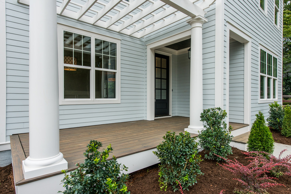 Inspiration for a mid-sized traditional front yard verandah in Raleigh with decking and a pergola.
