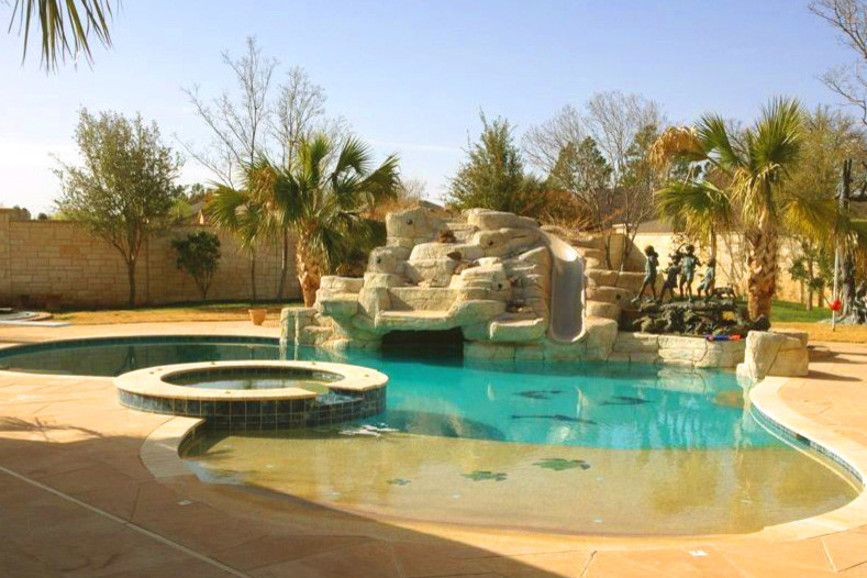 Inspiration for a mid-sized backyard stone and custom-shaped natural water slide remodel in Cincinnati