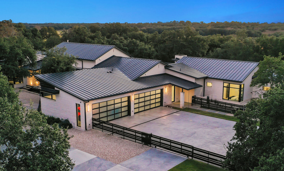 Design ideas for a contemporary attached four-car garage in Austin.