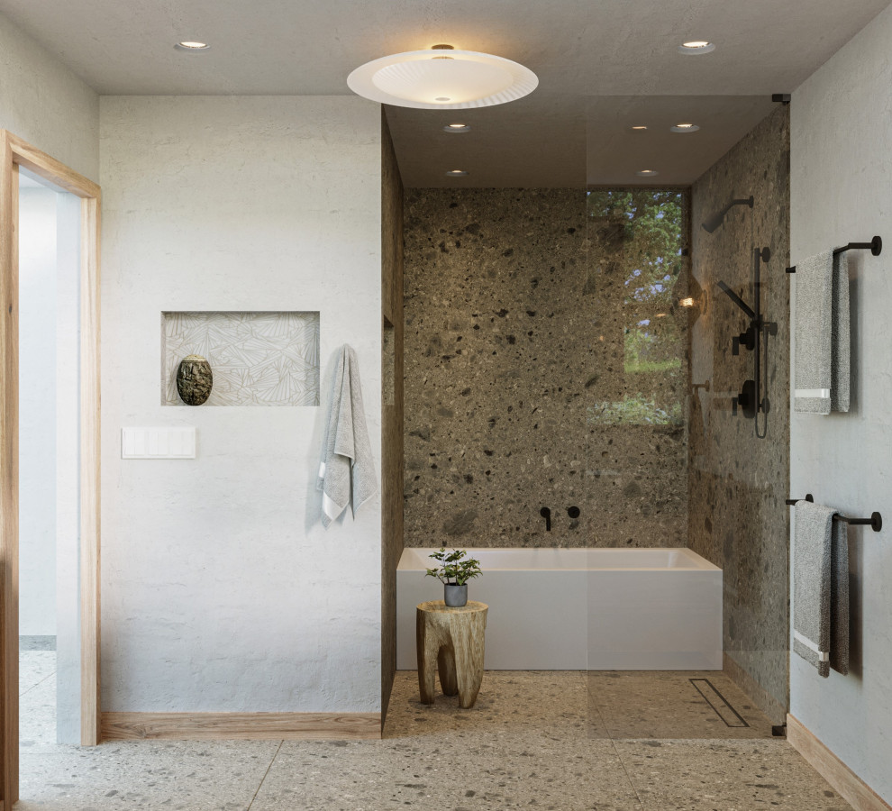 This is an example of a large scandinavian ensuite bathroom in Los Angeles with freestanding cabinets, light wood cabinets, an alcove bath, a walk-in shower, a wall mounted toilet, grey tiles, limestone tiles, white walls, limestone flooring, a submerged sink, limestone worktops, grey floors, an open shower, grey worktops, a wall niche, double sinks and a floating vanity unit.