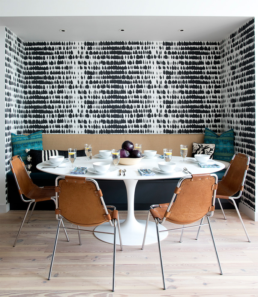 Design ideas for a contemporary dining room in New York with multi-coloured walls and light hardwood floors.
