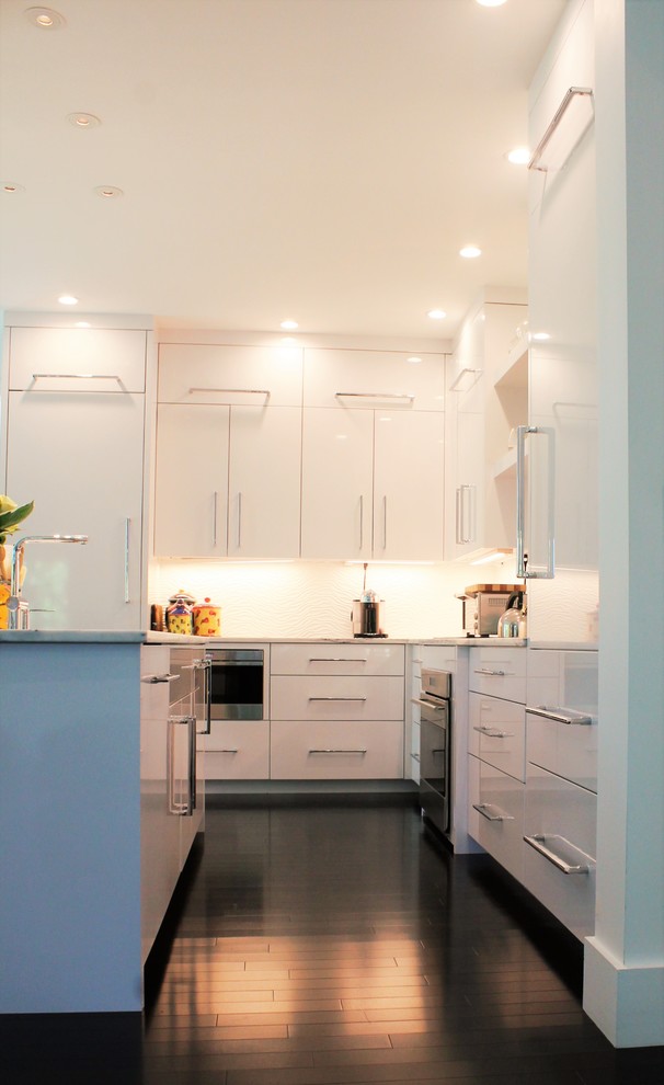 Open concept kitchen - mid-sized modern l-shaped dark wood floor open concept kitchen idea in Boston with an undermount sink, flat-panel cabinets, white cabinets, marble countertops, paneled appliances and an island