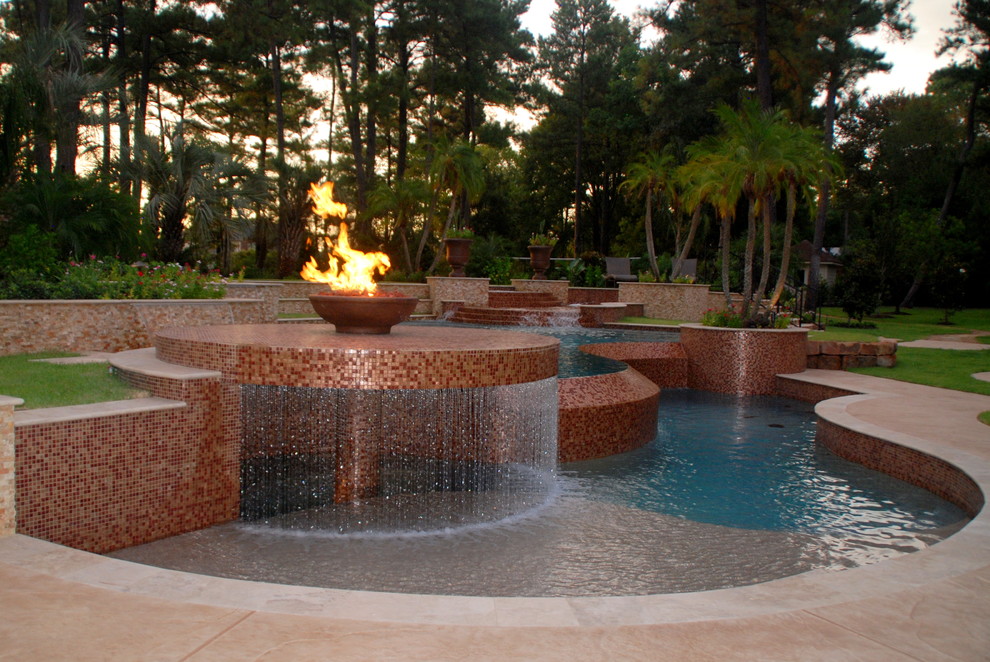 Photo of an expansive contemporary kidney-shaped infinity pool in Houston with tile.