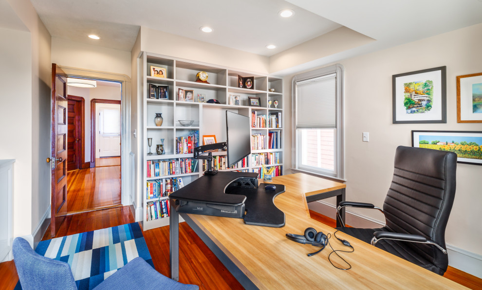 Inspiration for a medium sized traditional home office in Boston with beige walls, medium hardwood flooring, a freestanding desk and brown floors.