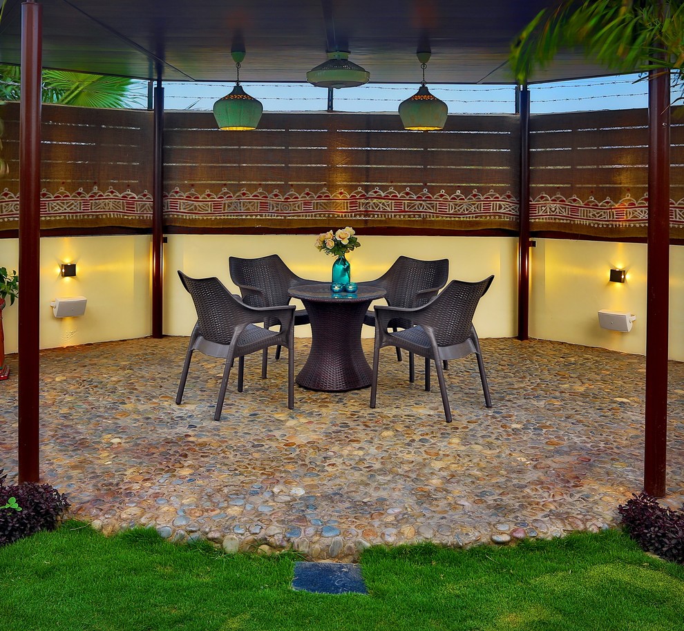 Design ideas for a Mid-sized eclectic patio With a Roof Extension.