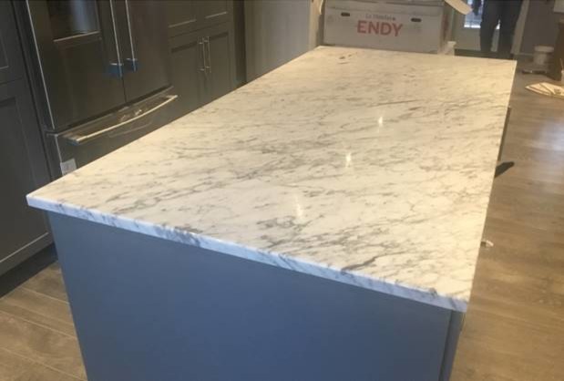 Example of a small transitional kitchen design with marble countertops, stainless steel appliances and white countertops