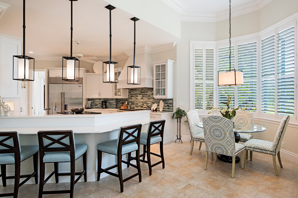 Example of a transitional eat-in kitchen design in Miami with recessed-panel cabinets, white cabinets, glass tile backsplash, stainless steel appliances and an island