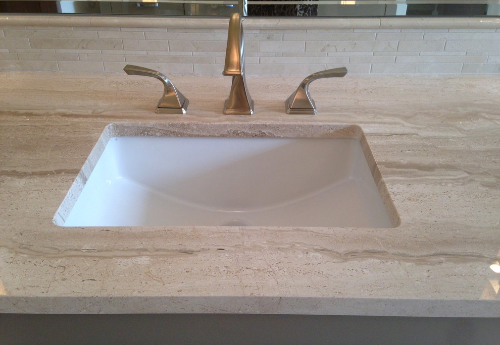 Photo of a transitional bathroom in Austin with marble benchtops and stone tile.