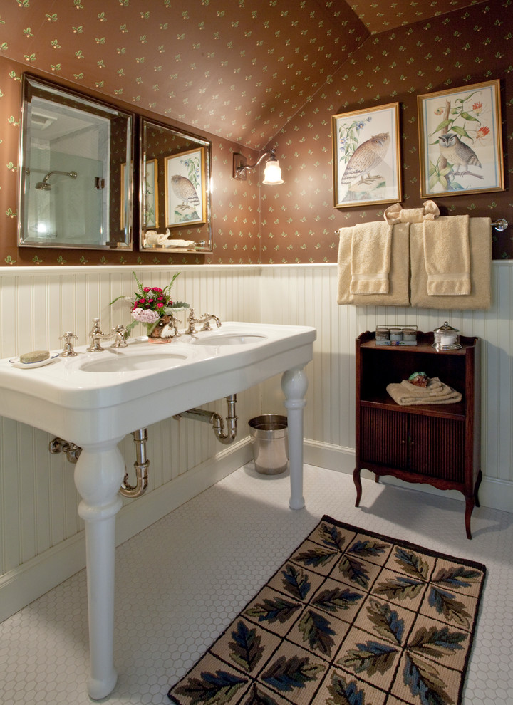 This is an example of a traditional bathroom in Burlington with a console sink, brown walls and mosaic tile floors.