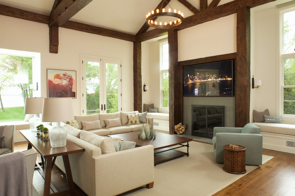 This is an example of an expansive country open concept family room in New York with medium hardwood floors, a standard fireplace and a stone fireplace surround.