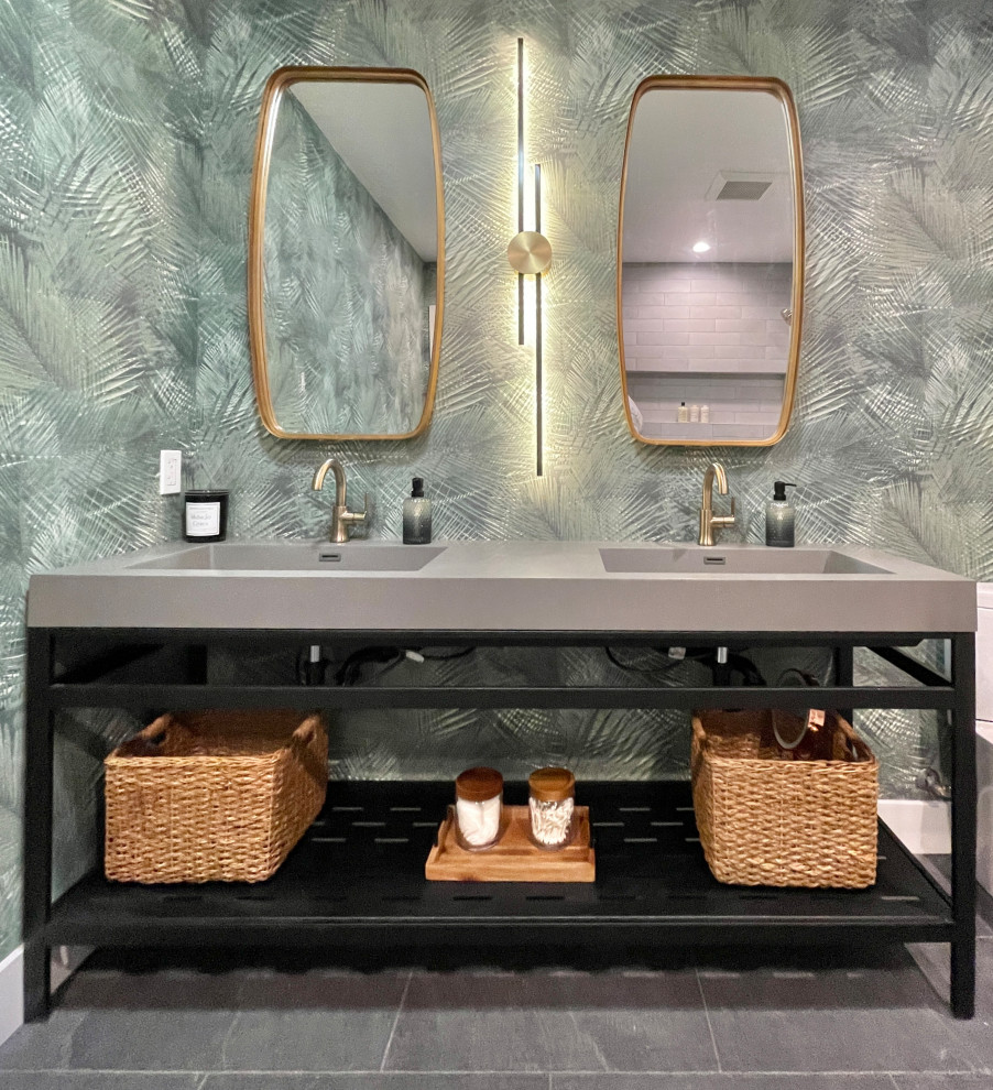 This is an example of a mid-sized contemporary 3/4 bathroom in San Diego with open cabinets, black cabinets, an alcove tub, a shower/bathtub combo, a two-piece toilet, green tile, green walls, slate floors, an integrated sink, concrete benchtops, grey floor, a shower curtain, grey benchtops, a double vanity, a freestanding vanity and wallpaper.
