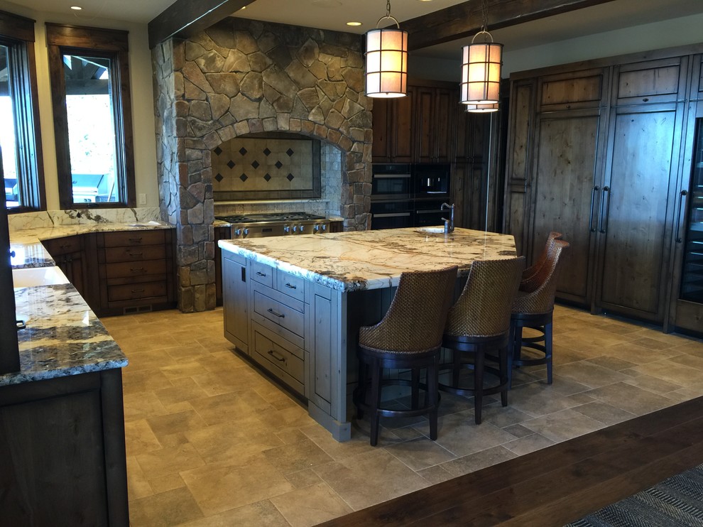 Example of a large mountain style u-shaped eat-in kitchen design in Seattle with flat-panel cabinets, dark wood cabinets, stone tile backsplash, stainless steel appliances, an island, a farmhouse sink and gray backsplash