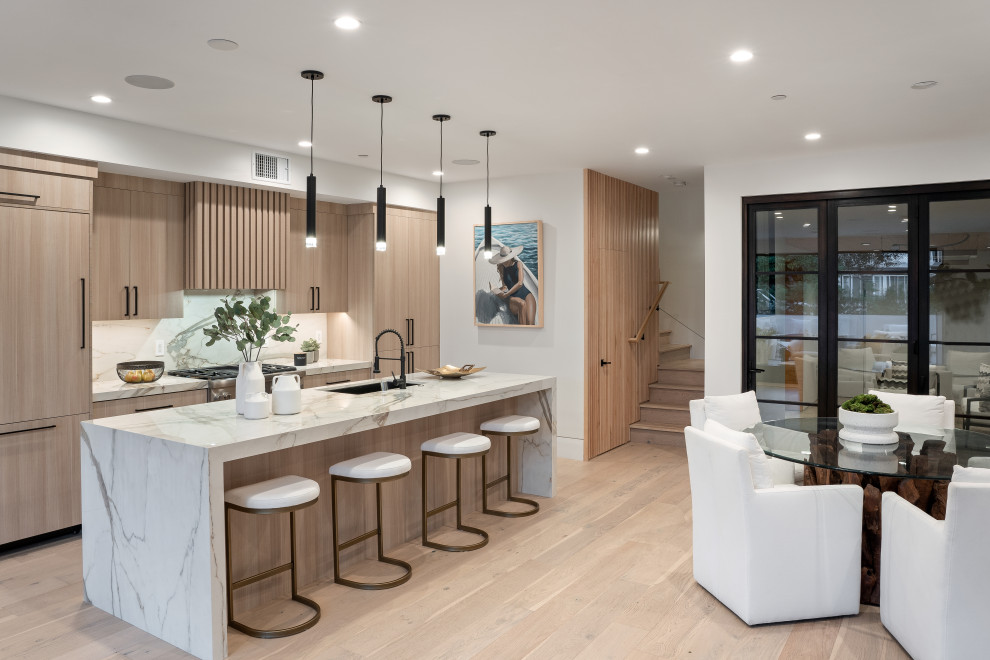 This is an example of an expansive contemporary galley eat-in kitchen in Los Angeles with with island.