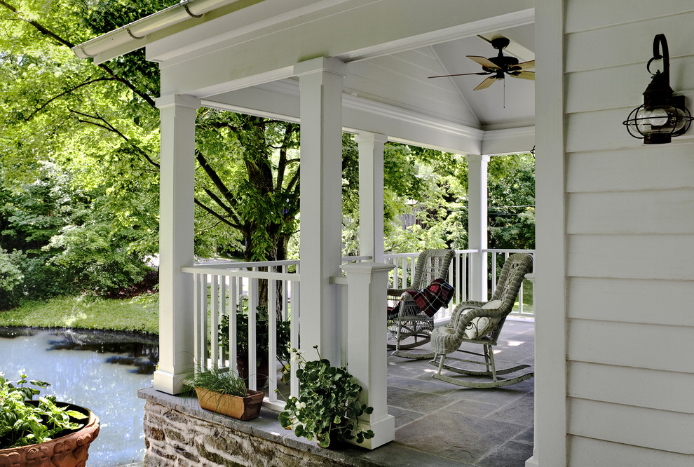 Inspiration for a traditional verandah in New York with a roof extension.