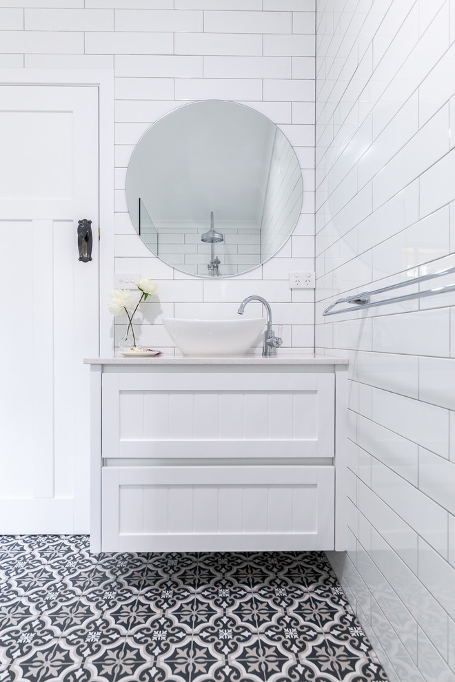 Design ideas for a mid-sized transitional master bathroom in Other with shaker cabinets, white cabinets, white tile, ceramic tile, white walls, ceramic floors, a vessel sink, engineered quartz benchtops, multi-coloured floor and beige benchtops.