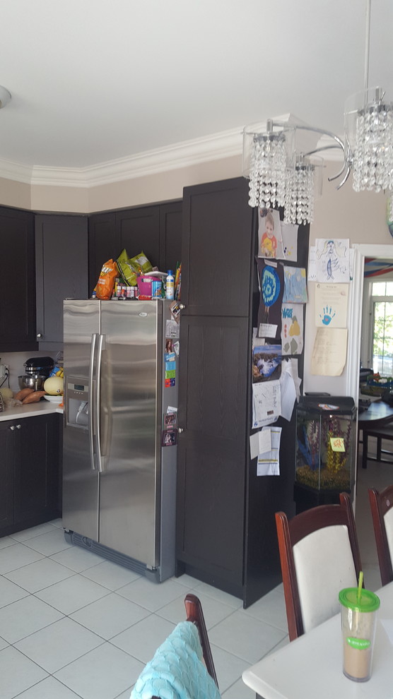Eat-in kitchen - mid-sized transitional galley dark wood floor eat-in kitchen idea in Toronto with an undermount sink, shaker cabinets, white cabinets, granite countertops, white backsplash, stone tile backsplash, stainless steel appliances and an island