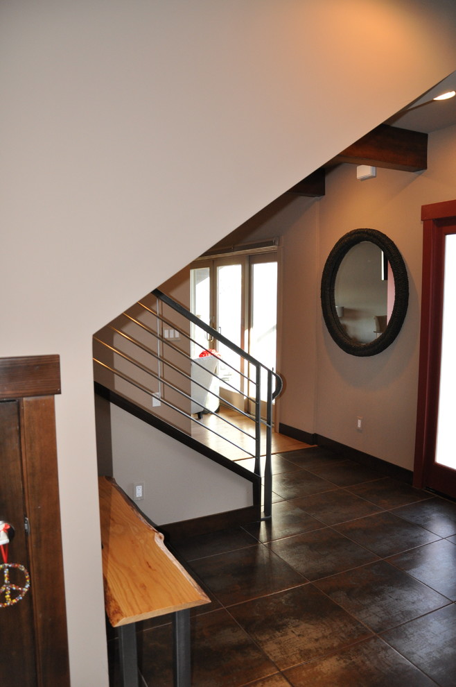 Foyer - mid-sized traditional porcelain tile and brown floor foyer idea with beige walls