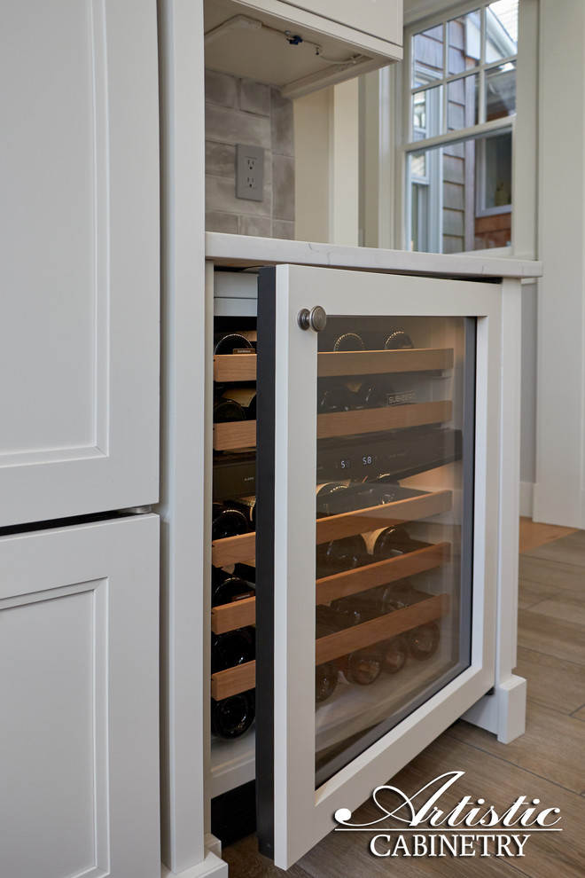 Mid-sized transitional u-shaped porcelain tile and beige floor open concept kitchen photo in New York with a farmhouse sink, shaker cabinets, white cabinets, quartzite countertops, gray backsplash, porcelain backsplash, stainless steel appliances, an island and gray countertops