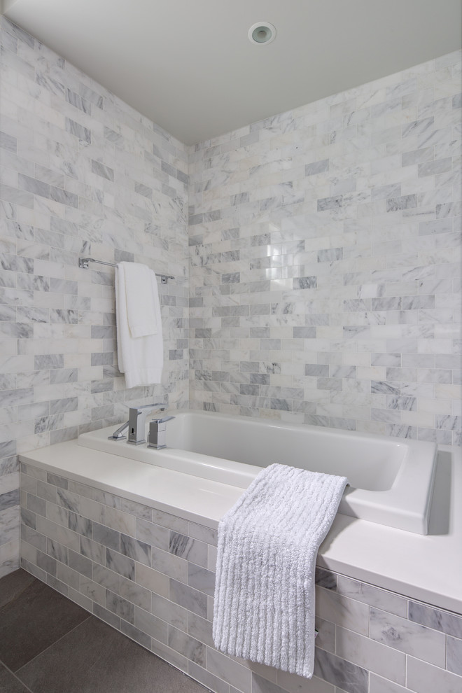 Design ideas for a mid-sized transitional master bathroom in Vancouver with shaker cabinets, white cabinets, a drop-in tub, a corner shower, a two-piece toilet, gray tile, marble, grey walls, porcelain floors, an undermount sink, engineered quartz benchtops, grey floor, a hinged shower door and white benchtops.