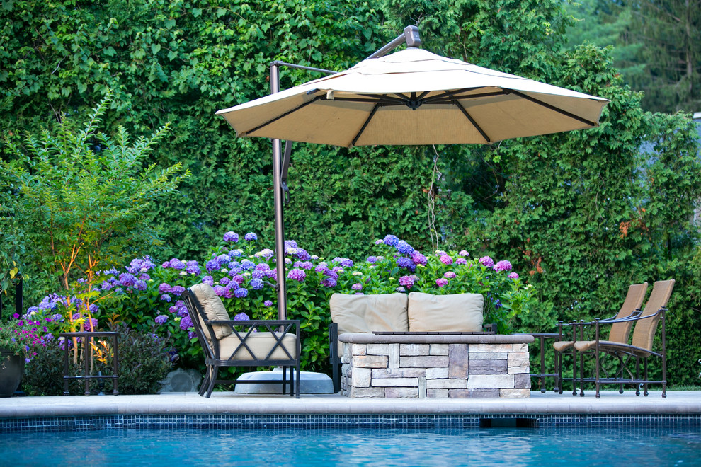 Inspiration for a traditional backyard custom-shaped pool in New York.